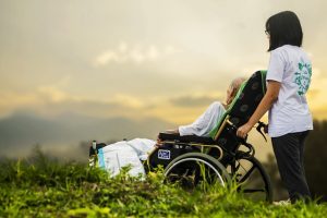 Lady pushing her best friend's wheelchair