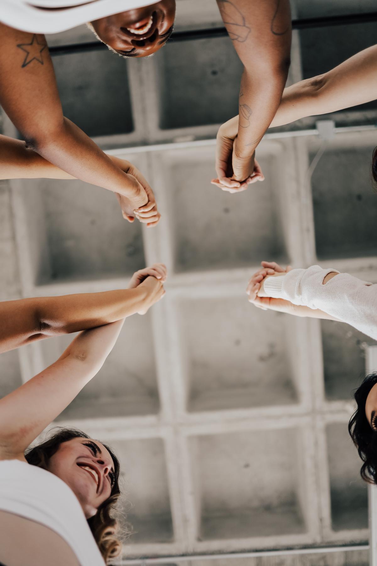 A group of friends supporting each other, symbolizing the importance of drawing strength from friends and family during a breakup.
